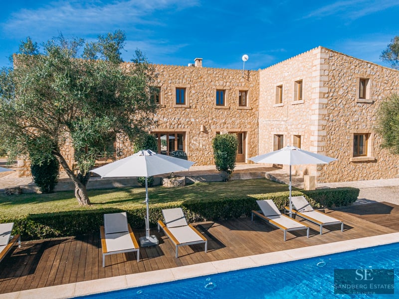 Spacious living room with balcony and panoramic sea view. Modern design, light wood floors, and designer furniture. Natural lighting.