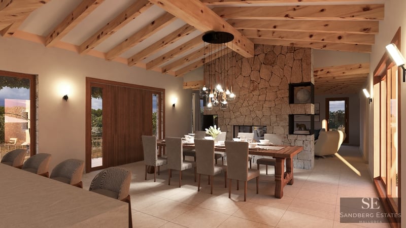 Interior view of a luxury dining room with high wooden beam ceilings, a natural stone feature wall, and a large dining table.