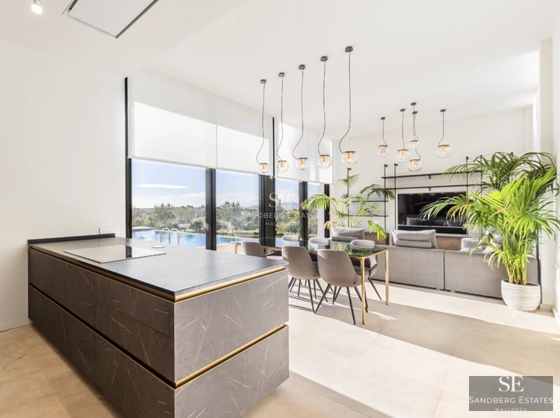 Exterior view of a modern villa with infinity pool, sun loungers, and garden area. Contemporary architecture, ideal for relaxation.