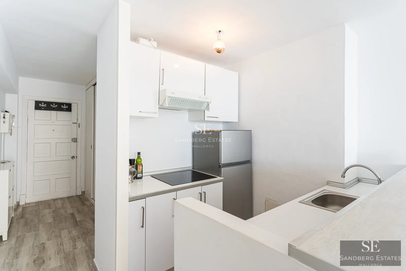 Spacious balcony with sea view. Glass railing, wooden floor and modern furniture create an elegant and relaxing space.