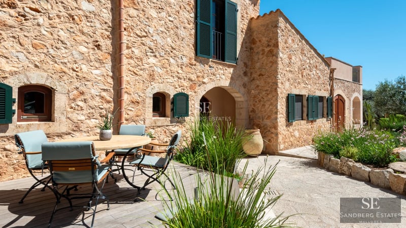 Exterior view of a modern villa with pool, large windows, and minimalist design. Well-manicured garden. Ambient lighting.