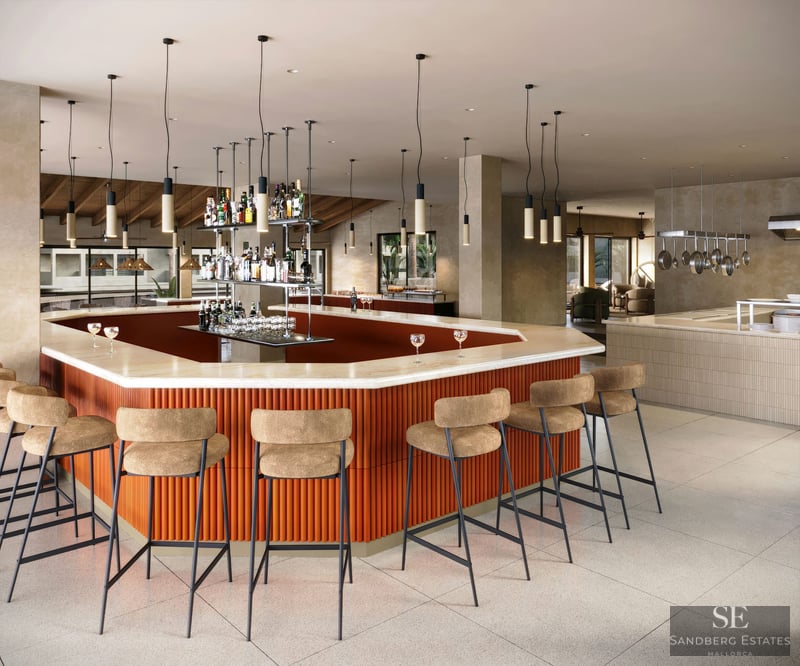 Modern bar with orange fluted base, marble top, and beige stools under hanging pendant lights in a spacious lounge.