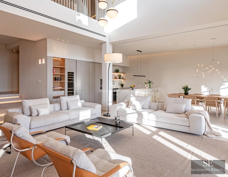 Expansive terrace with infinity pool. Modern design featuring wood flooring and ocean views. Loungers and umbrellas for relaxation.