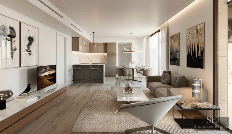 Modern living room featuring a beige sofa, marble coffee table, wood flooring, and an integrated kitchen in the background.