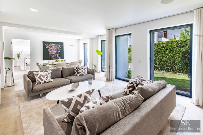 View of modern villa with infinity pool, expansive terraces and lush garden. Minimalist architectural design with natural light.