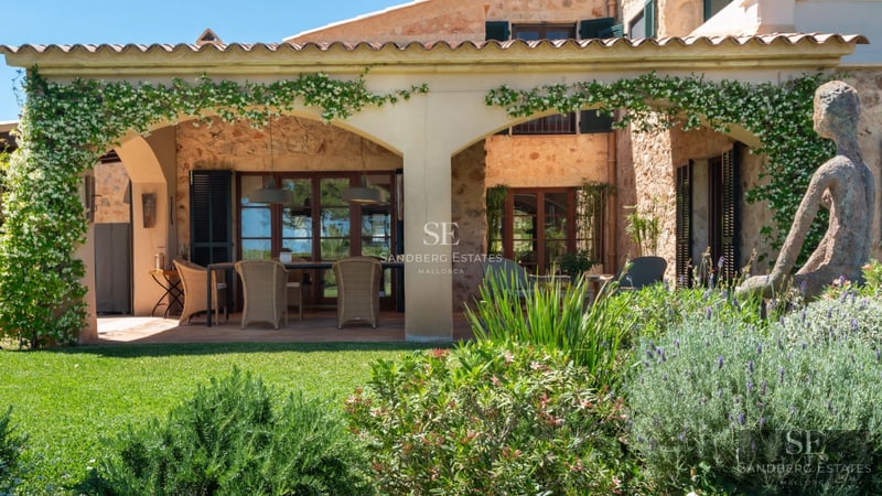 Exterior view of a modern house with a pool, garden and large balcony. Minimalist architecture and high-quality finishes.