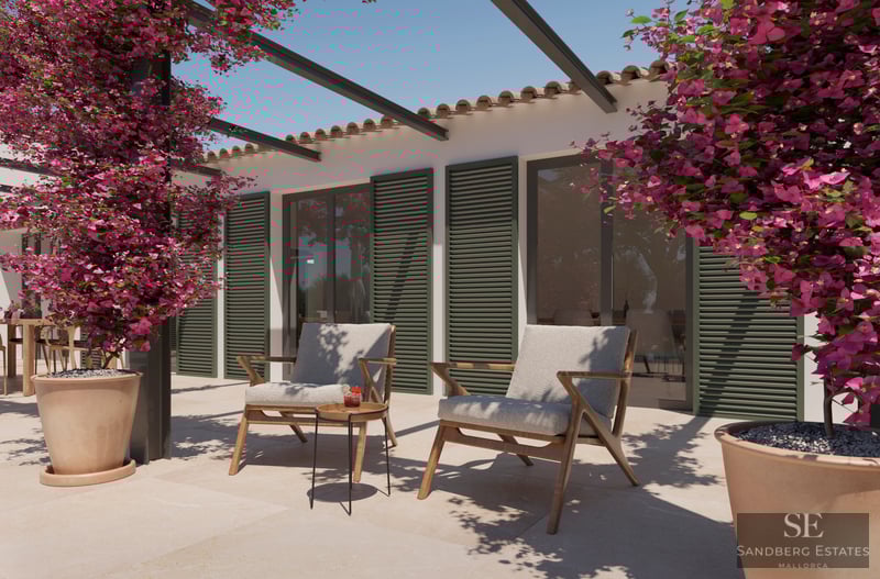 Stone terrace with two wooden armchairs, green shutters, and vibrant pink bougainvillea under a clear sky.