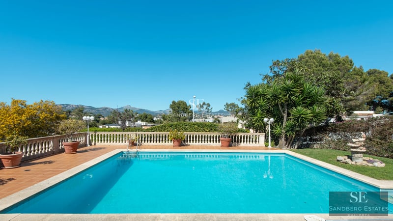 Exterior view of a modern villa with a pool, lush garden, and large terraces. Sleek, minimalist design with abundant natural light.