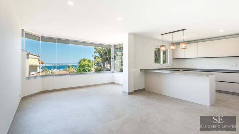 Exterior view of a modern villa featuring an infinity pool, surrounded by a garden and large windows. Minimalist architecture.