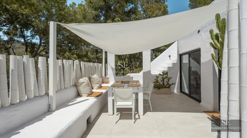 Minimalist interior with large windows, light wood floors, and modern furniture. Abundant natural light.