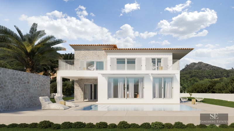 Modern white villa with a pool, stone wall accents, and scenic mountains under a blue sky.