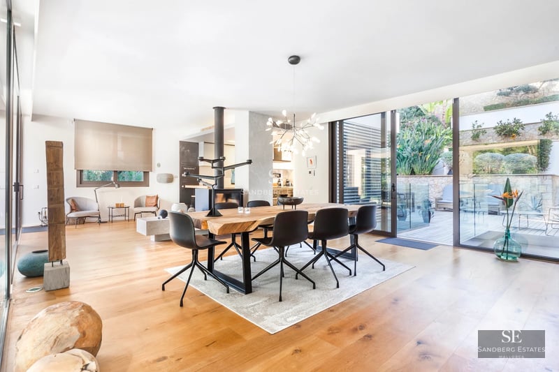 Modern exterior with reflecting pool, lush gardens, and large windows. Minimalist architecture and elegant landscaping.