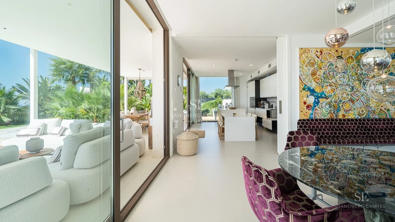 Expansive terrace featuring an infinity pool with ocean views. Modern design, elegant furnishings, and lush greenery.