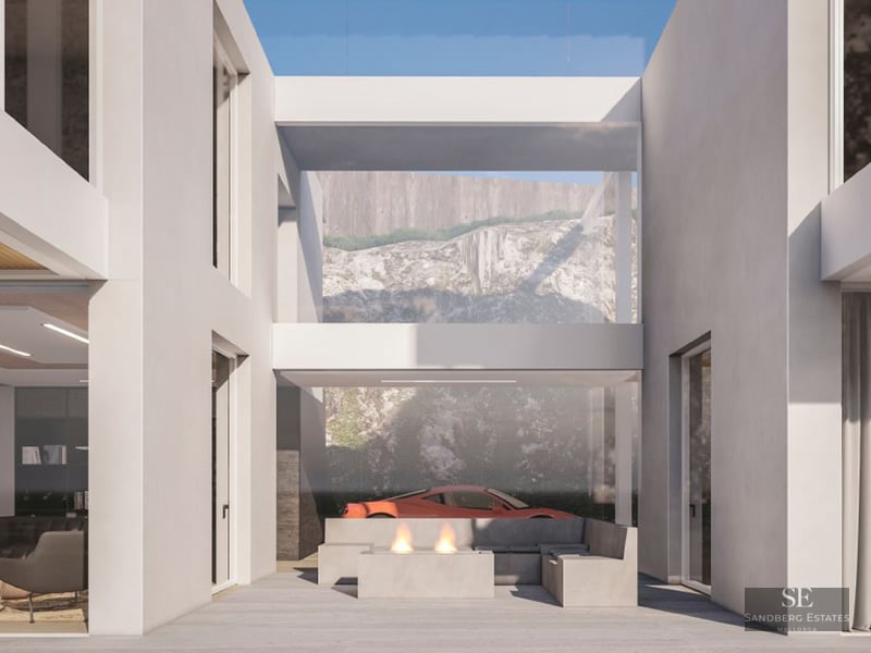 Minimalist white terrace featuring a modern fire pit, concrete seating, and a red sports car visible in the background.