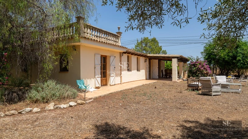 Image of a modern house with a swimming pool, patio, and lush garden. Contemporary architecture and appealing exterior design.