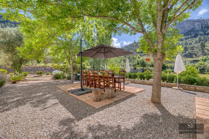 Exterior view of modern villa with reflecting pool. Minimalist architecture, large windows, and elegant landscaping.