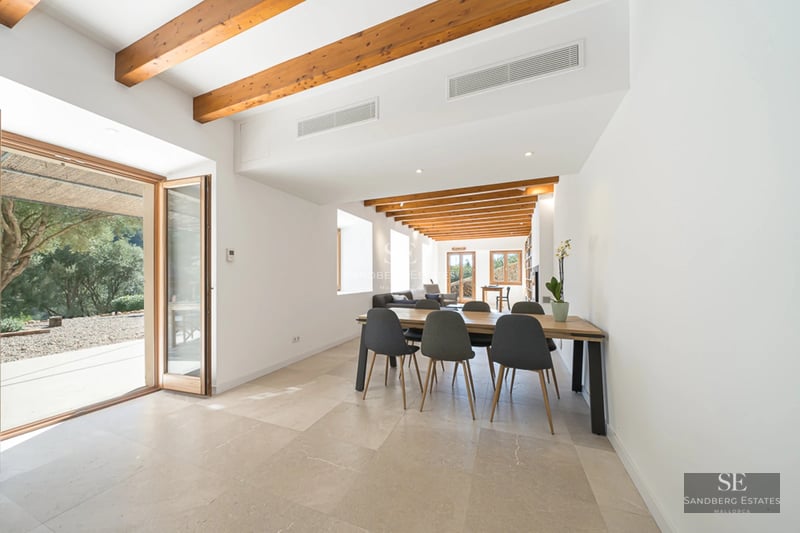 Exterior view of a modern villa with pool, expansive terraces, minimalist design, and lush greenery. White facade and large windows.