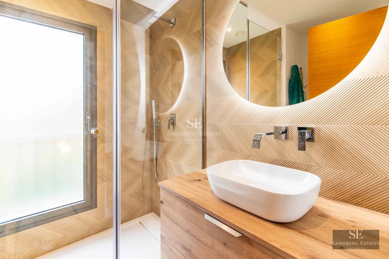 Spacious balcony with private pool and panoramic sea views. Modern design with glass railing and sun loungers.