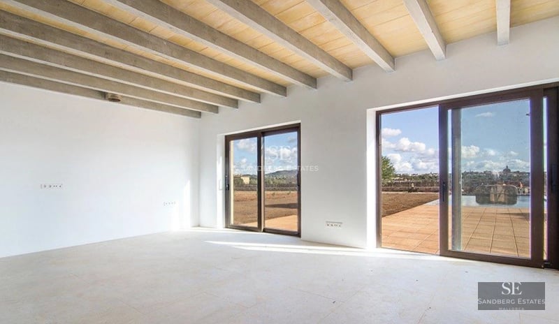 Exterior view of a modern villa with an infinity pool, large garden, and terrace with panoramic sea views. Minimalist architecture.