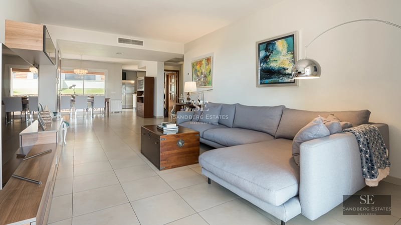 Aerial view of a modern villa with reflective pool, lush gardens and minimalist architecture. Contemporary design and high-end finishes.