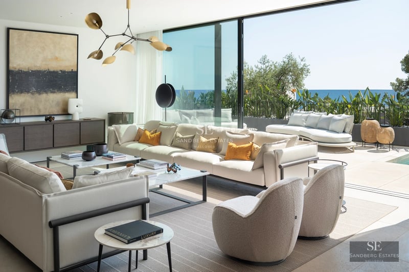 Exterior view of a modern villa with a pool, lush garden and extensive outdoor living areas. Contemporary design.