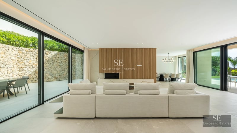 Spacious terrace with infinity pool, sun loungers, sea views. Modern, minimalist design with white walls and abundant natural light.