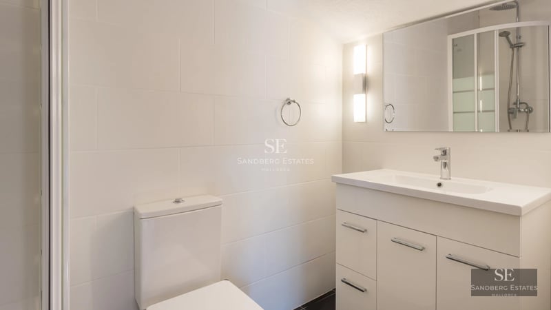 Exterior view of modern villa with reflecting pool, minimalist design, and expansive green spaces. Warm ambient lighting.