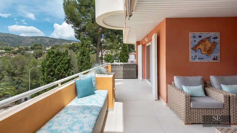 Exterior of a modern villa with reflecting pool, large windows, and lush vegetation. Contemporary architectural design.