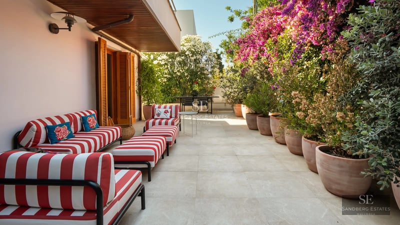 Spacious living room with large windows, modern fireplace and elegant furniture. Panoramic outdoor views.