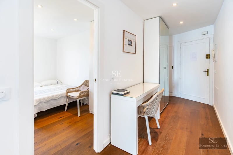 Exterior view of a modern villa with a pool, garden, and large windows reflecting sunlight. Minimalist and elegant design.