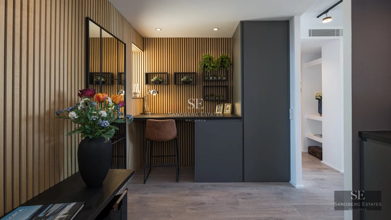 Spacious balcony with panoramic sea view. Elegant outdoor furniture and glass railing.