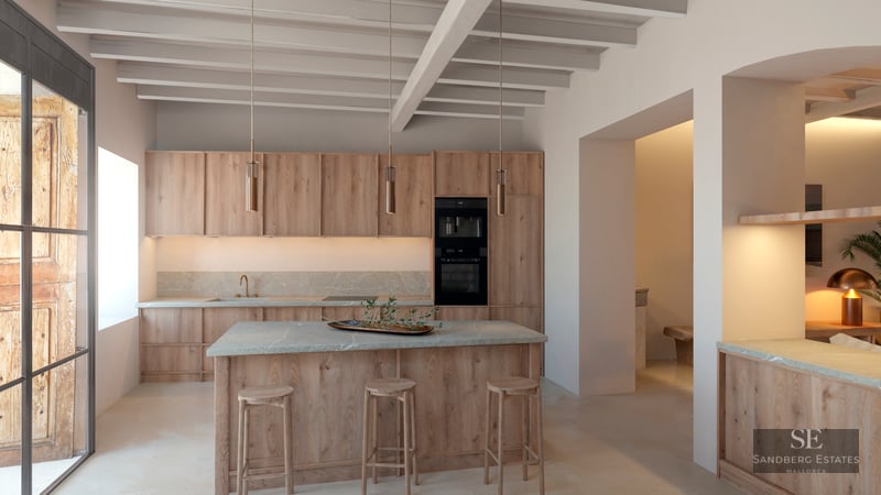 Luxury kitchen featuring light wood cabinets, stone island with stools, and exposed ceiling beams.
