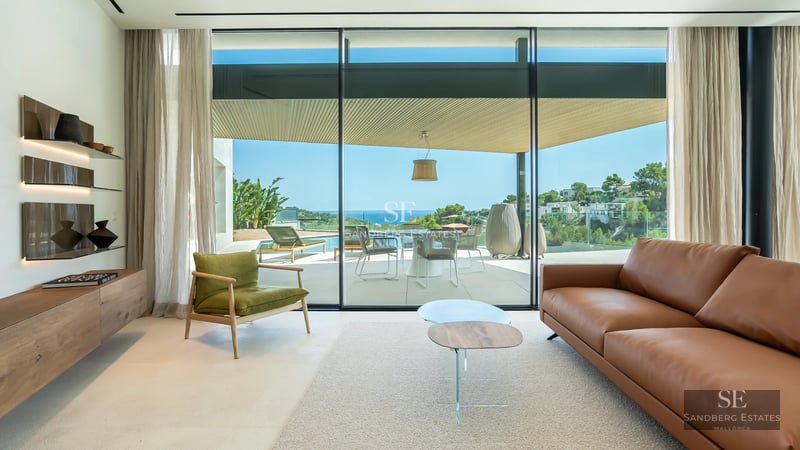 Exterior view of a modern villa with an infinity pool, manicured gardens, and minimalist architectural design. Warm ambient lighting.