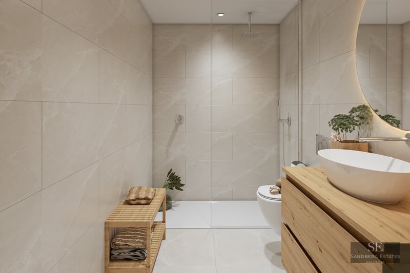Modern bathroom with beige tiles, walk-in glass shower, wooden vanity, white vessel sink, and backlit circular mirror.
