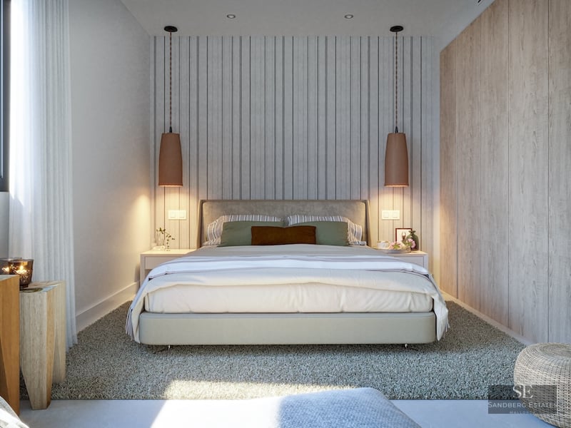 Modern bedroom featuring a large bed, wood paneling, designer pendant lights, and a plush grey rug.