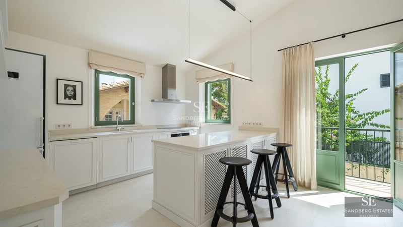 Modern exterior with infinity pool, wooden deck, sea view, and minimalist architecture. Green lawn and natural light.