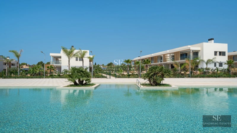 Spacious terrace with pool and lush garden. Modern architecture with large windows and stylish outdoor furniture.