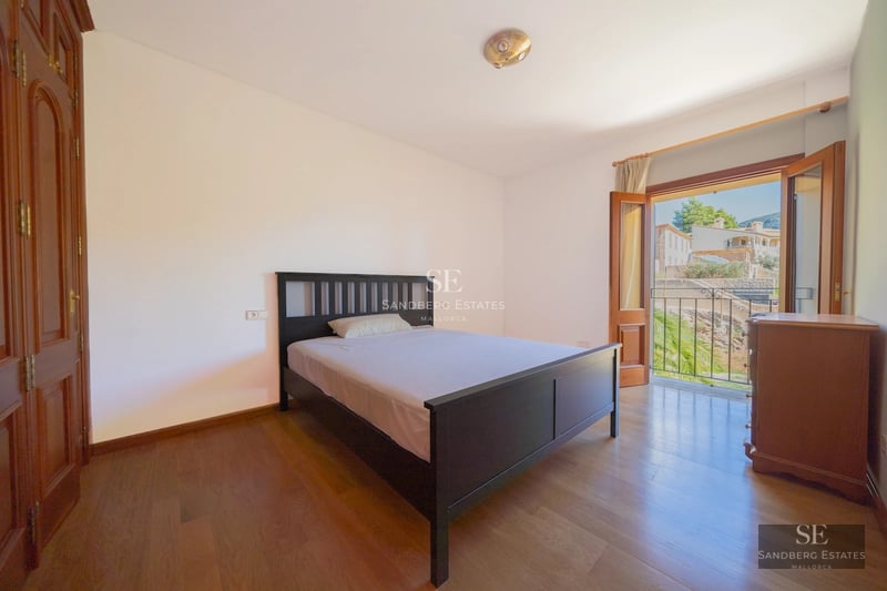 Exterior view of a modern house with a pool, lush greenery, and large windows. Contemporary architectural design.