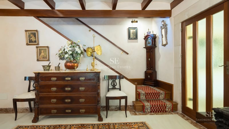 Spacious balcony with sea view, pool, and modern furniture. Designer lighting fixtures and lush greenery.