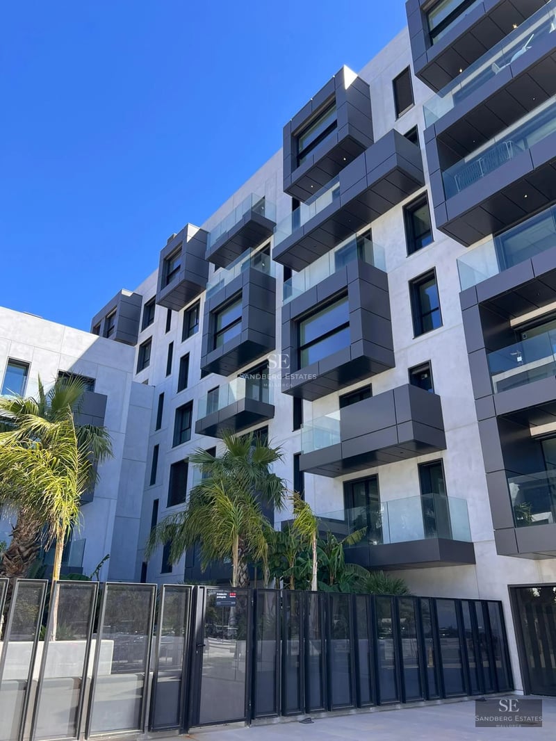 Bright living room with large windows offering panoramic sea views. Modern design, elegant furniture and wooden floor.