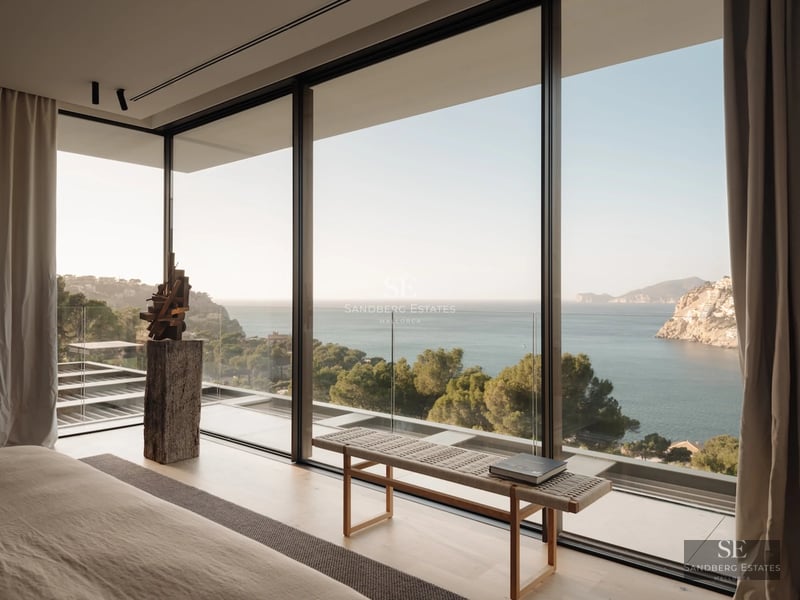 Expansive terrace with infinity pool and sea views. Modern, minimalist design, elegant and relaxing outdoor furniture.