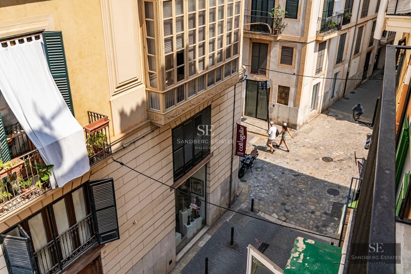 Exterior of a modern villa with a pool, large windows, minimalist design, and lush surrounding vegetation.