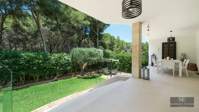 Spacious, bright living room with large windows and panoramic sea views. Modern sofa and elegant decor.