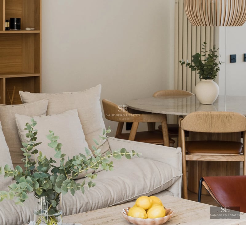 View of modern villa with infinity pool, manicured garden, and minimalist facade. Soft ambient lighting and blue sky.