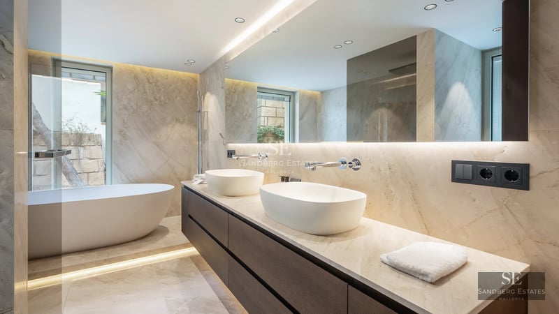 Balcony view featuring a glass railing, infinity pool, and panoramic ocean views. Modern and minimalist furniture. Bright and spacious.