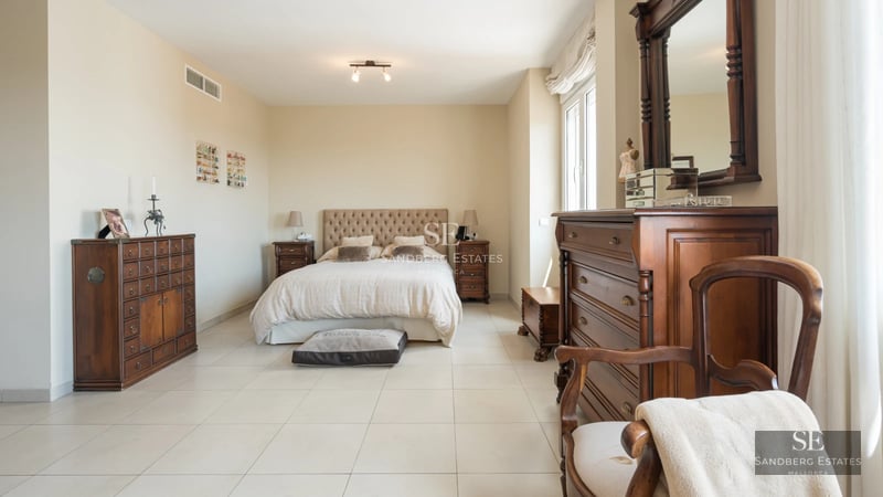 Balcony with glass railing offering panoramic sea views. Modern outdoor furniture. Minimalist and elegant design.