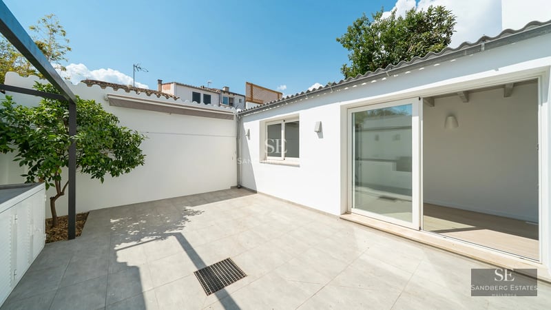 View of a modern villa featuring an infinity pool, sun loungers, and expansive garden. Minimalist architecture, perfect for relaxation.