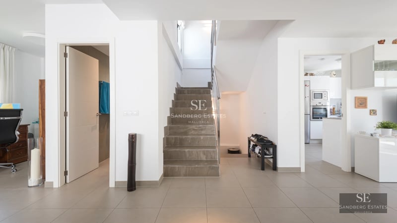 Exterior view of a luxurious villa featuring a pool, garden, and modern architectural design. Ambient lighting and natural textures.