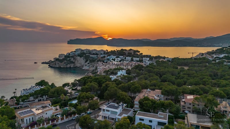 View of a modern villa with infinity pool. Minimalist design, large windows, and lush gardens. Luxurious and tranquil atmosphere.