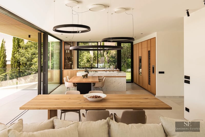 Modern facade with reflective pool, large windows, and minimalist design. Ambient lighting and lush vegetation.